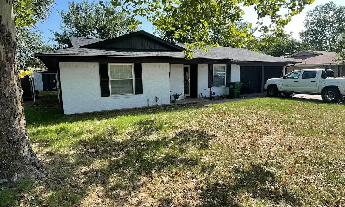 Professional roofing crew working on a residential roof in Clifton Park